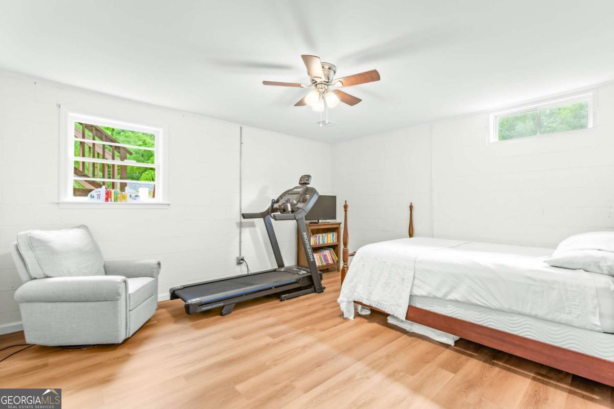 764 Sandy Cross Road Lexington, GA 30648 - Photo 35 of 52 a bedroom with a bed and a couch