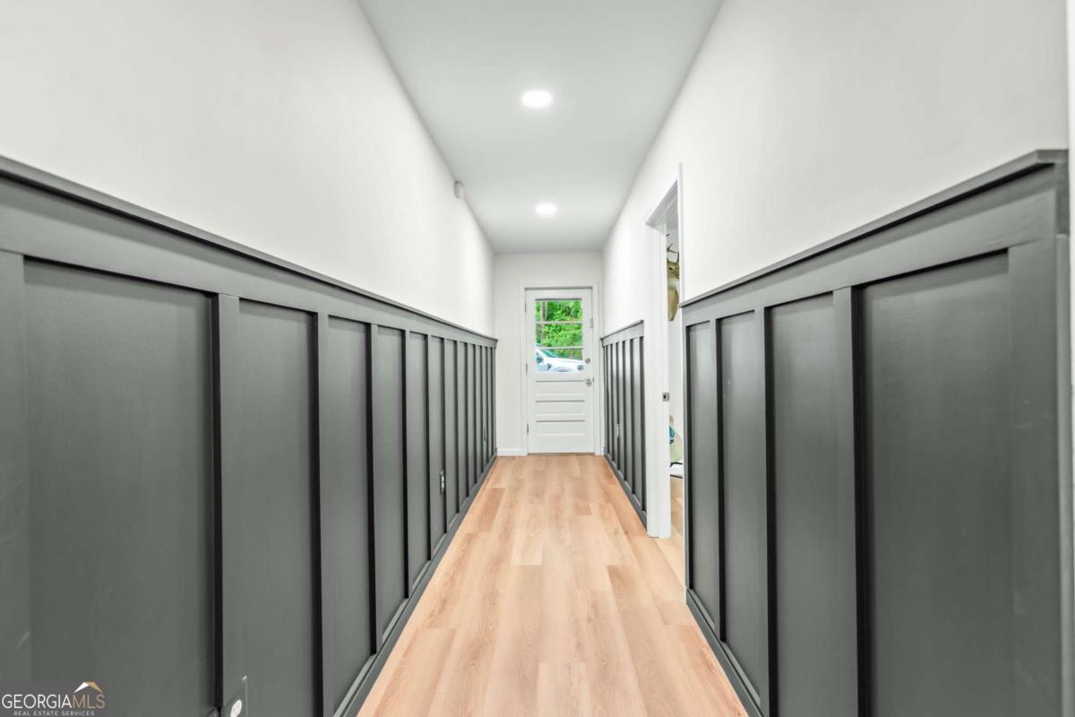 764 Sandy Cross Road Lexington, GA 30648 - Photo 38 of 52 a view of a hallway with wooden floor and staircase