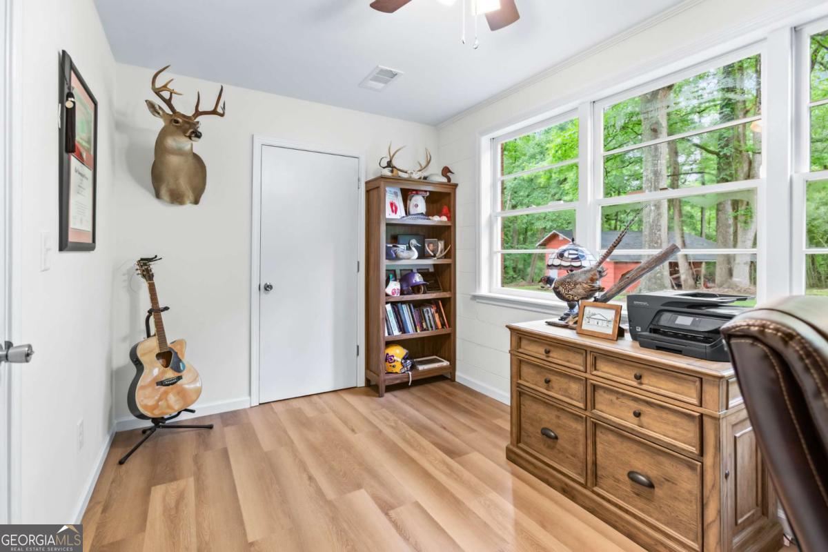 764 Sandy Cross Road Lexington, GA 30648 - Photo 42 of 52 a bedroom with a bed and a book shelf
