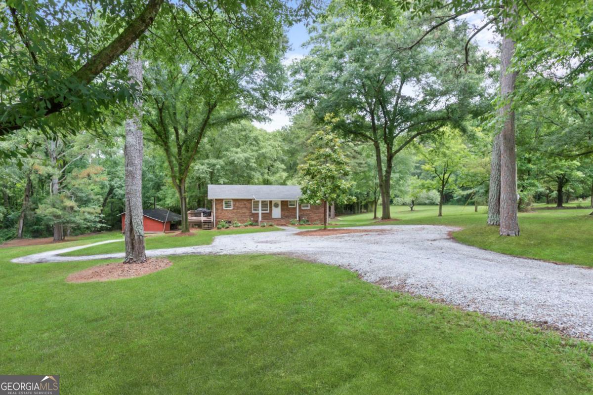 764 Sandy Cross Road Lexington, GA 30648 - Photo 44 of 52 a view of a park with large trees and a large tree