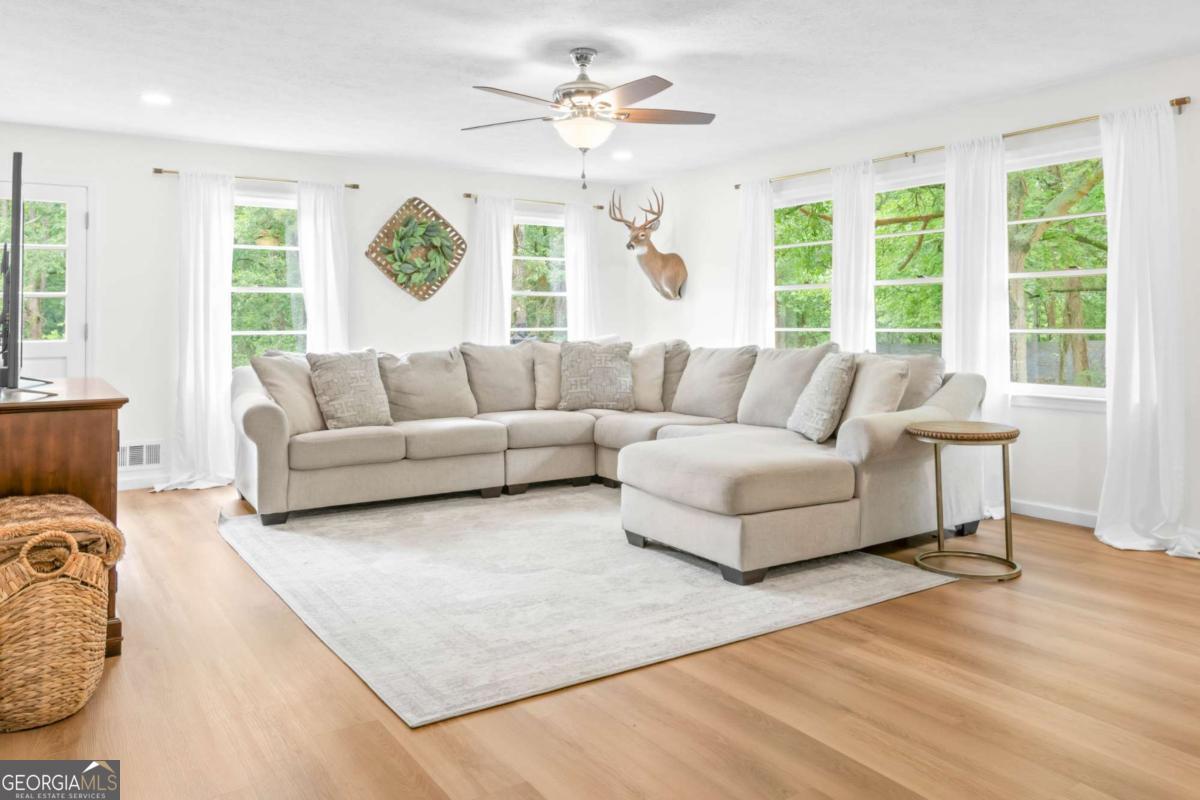 764 Sandy Cross Road Lexington, GA 30648 - Photo 9 of 52 a living room with furniture and a large window