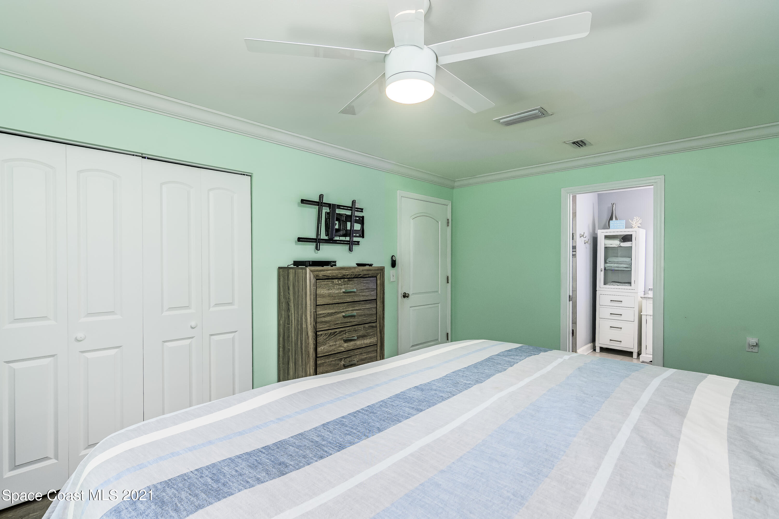 1740 Vally Road Malabar, FL 32950 - Photo 10 of 42 a bedroom with a bed and a chandelier