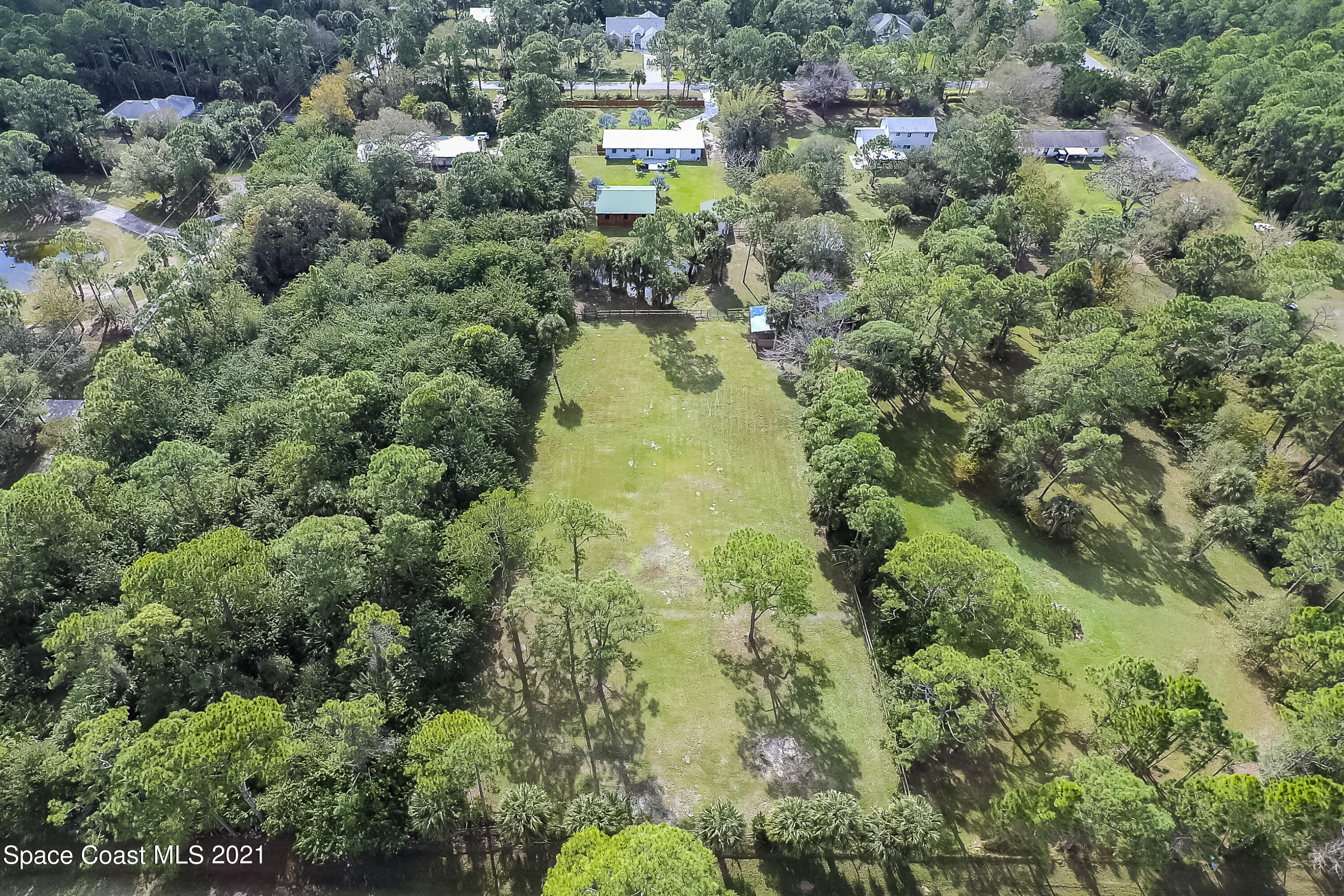 1740 Vally Road Malabar, FL 32950 - Photo 40 of 42 an aerial view of residential houses with outdoor space and trees