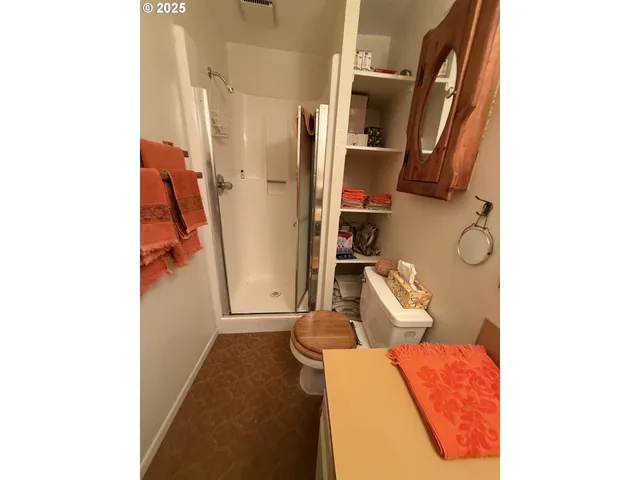 a view of a storage room with water heater and racks