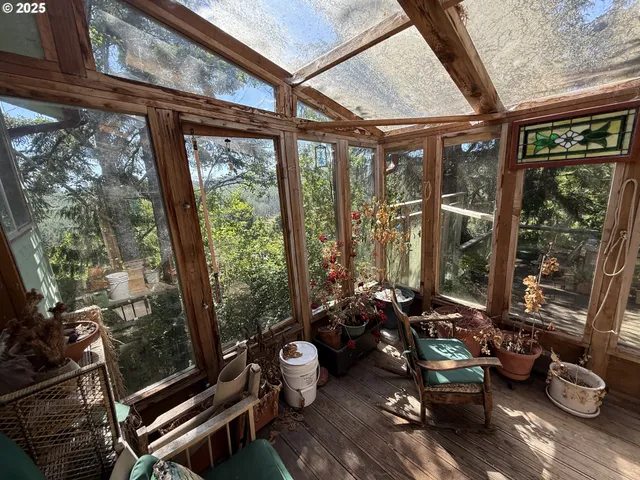 a view of balcony with wooden floor and outdoor seating