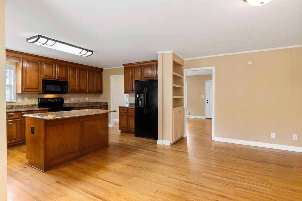 439 East Madison Street Pulaski, TN 38478 - Photo 13 of 36 a large kitchen with stainless steel appliances a refrigerator and a stove top oven