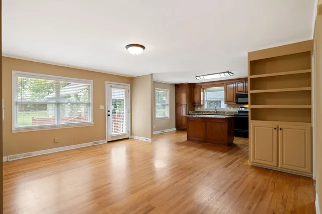 a kitchen with stainless steel appliances kitchen island wooden cabinets and granite counter tops