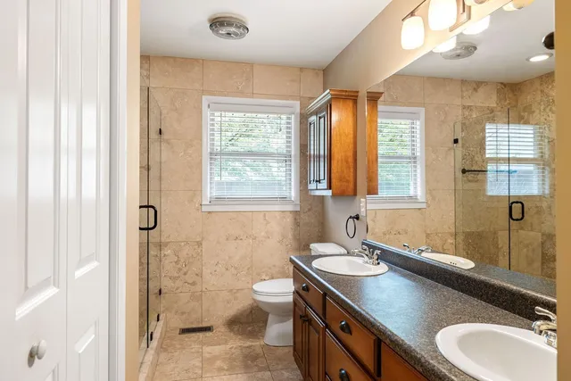 a bathroom with a sink double vanity and a mirror