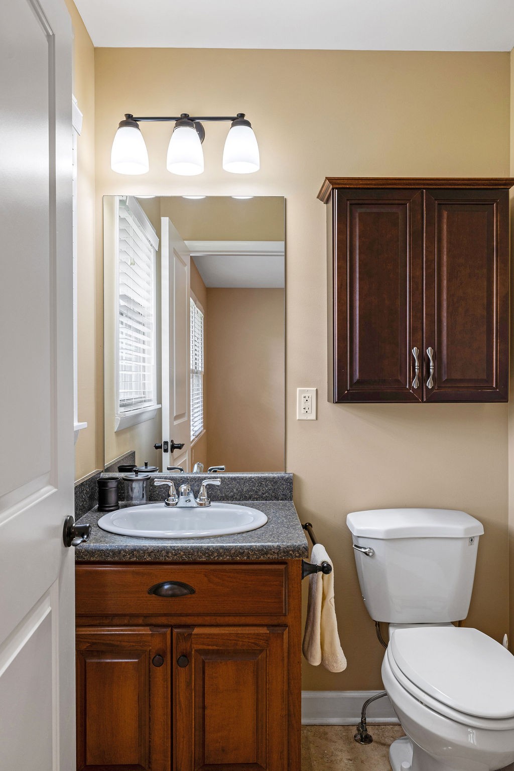439 East Madison Street Pulaski, TN 38478 - Photo 24 of 36 a bathroom with a toilet a sink and mirror