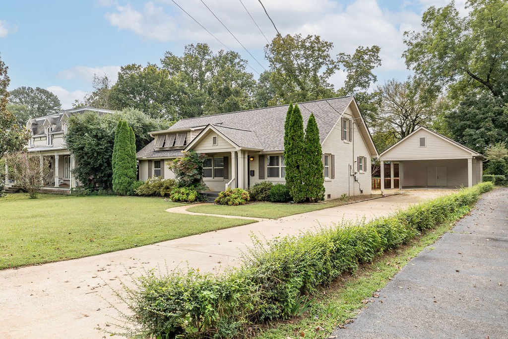 439 East Madison Street Pulaski, TN 38478 - Photo 3 of 36 a front view of a house with a yard and trees