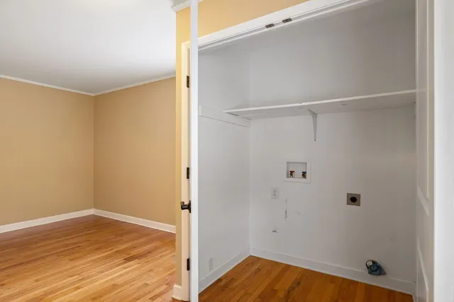 a view of a room with wooden floor