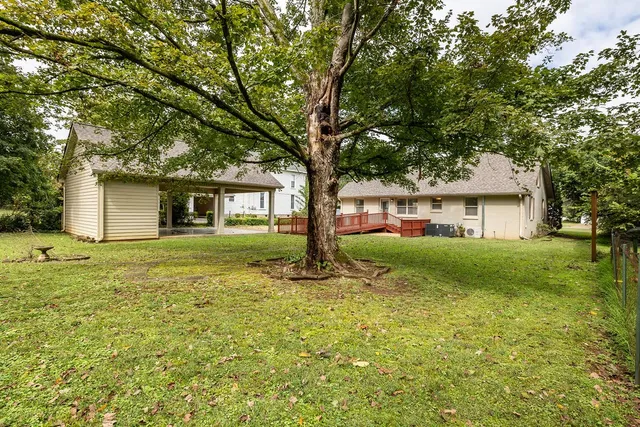 a front view of a house with yard and green space