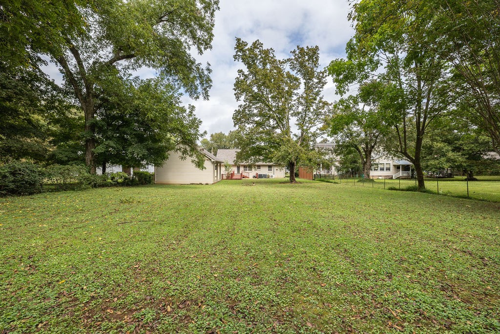 439 East Madison Street Pulaski, TN 38478 - Photo 9 of 36 a view of outdoor space with deck and trees