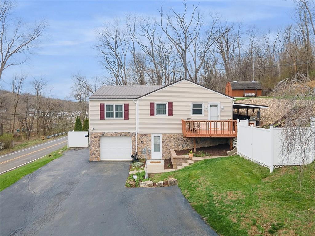 7826 Noblestown Road McDonald, PA 15057 - Photo 1 of 48 a front view of a house with a garden and yard