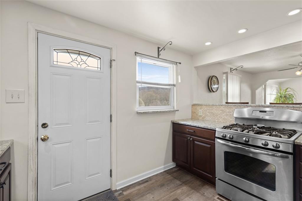 7826 Noblestown Road McDonald, PA 15057 - Photo 11 of 48 a kitchen with stainless steel appliances granite countertop white cabinets and window