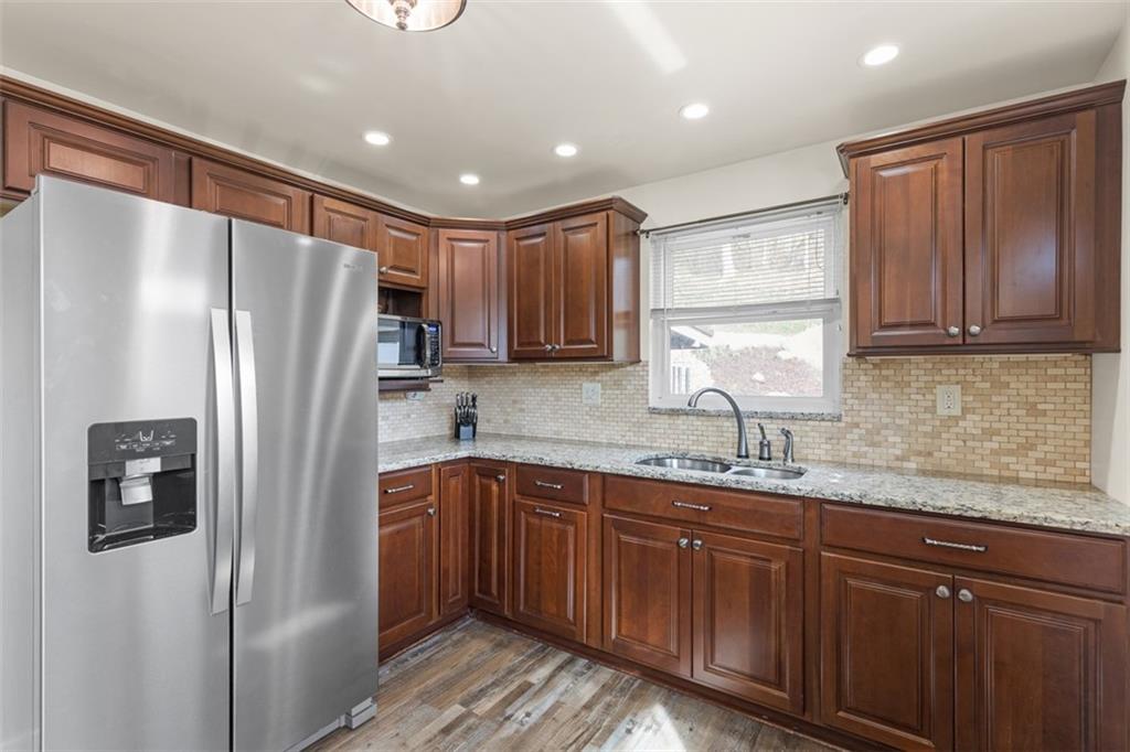 7826 Noblestown Road McDonald, PA 15057 - Photo 9 of 48 a kitchen with stainless steel appliances granite countertop a refrigerator a sink and dishwasher