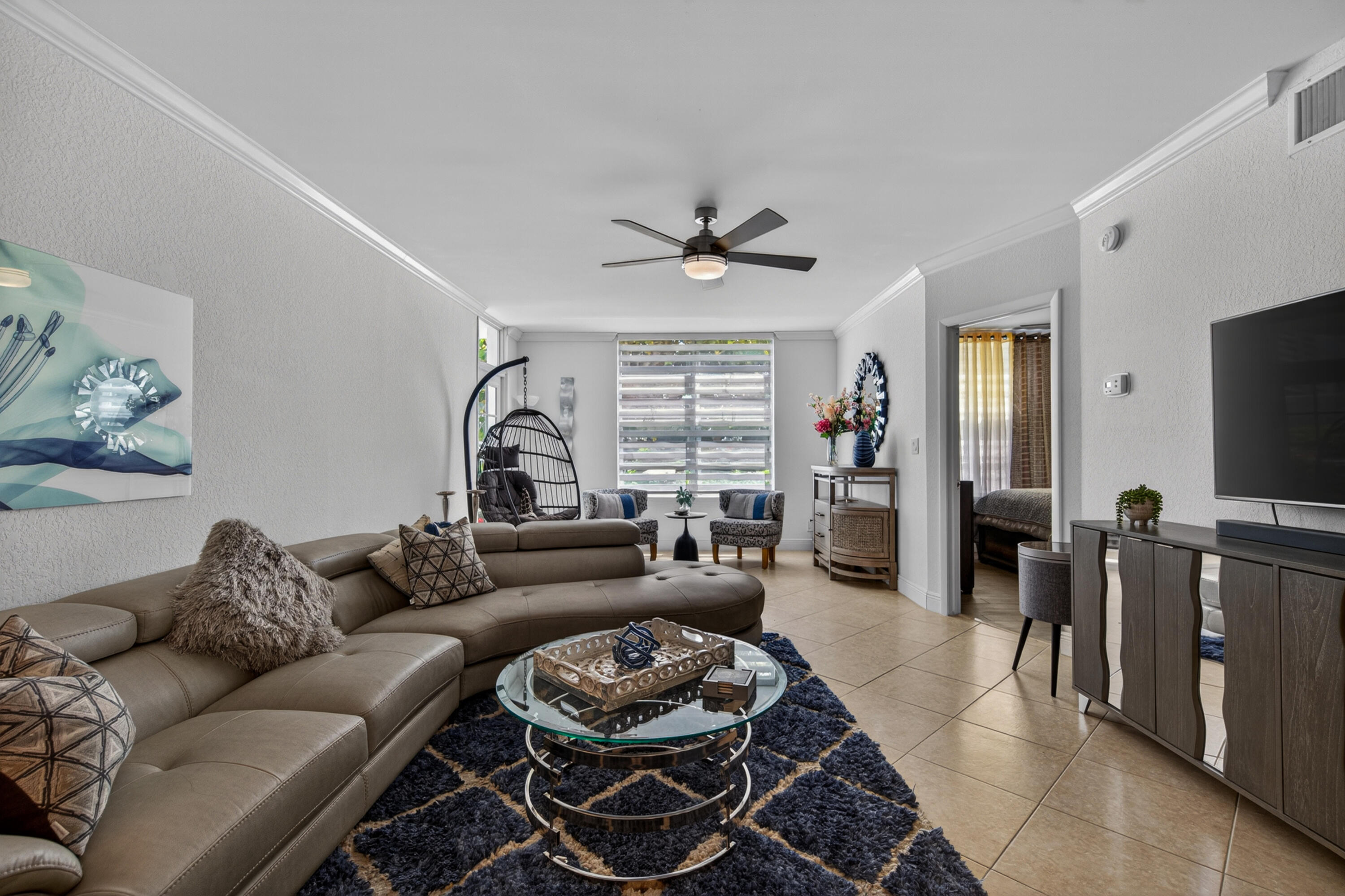 2851 South Ocean Boulevard, Unit 1N Boca Raton, FL 33432 - Photo 13 of 54 a living room with furniture a window and a flat screen tv