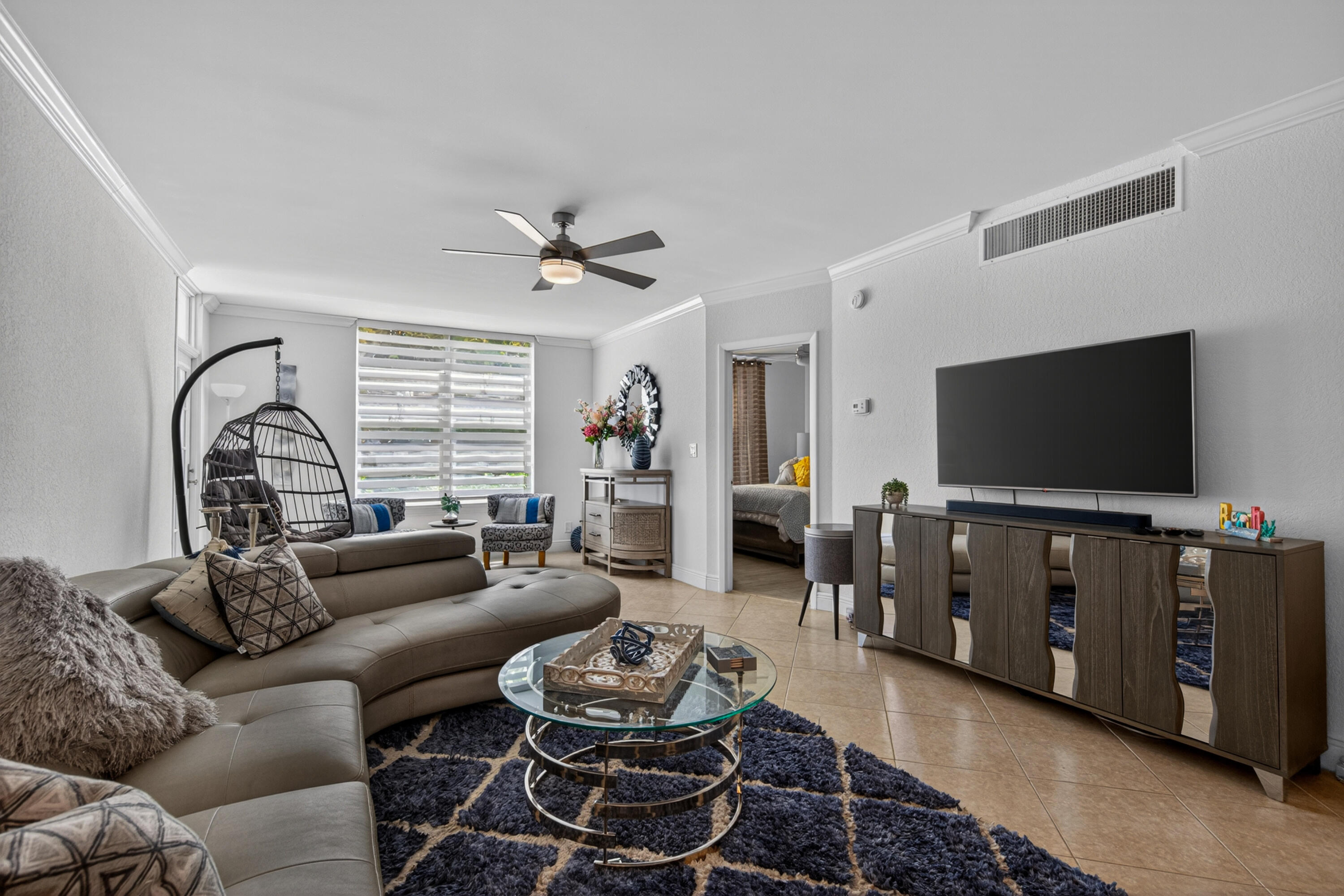 2851 South Ocean Boulevard, Unit 1N Boca Raton, FL 33432 - Photo 16 of 54 a living room with furniture and a flat screen tv