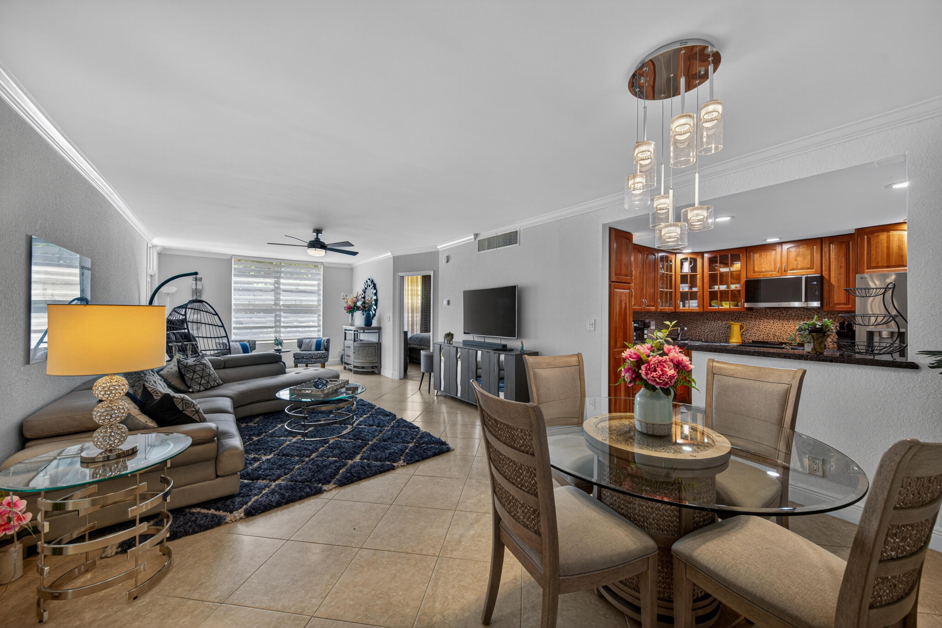 2851 South Ocean Boulevard, Unit 1N Boca Raton, FL 33432 - Photo 17 of 54 a living room with furniture and a chandelier