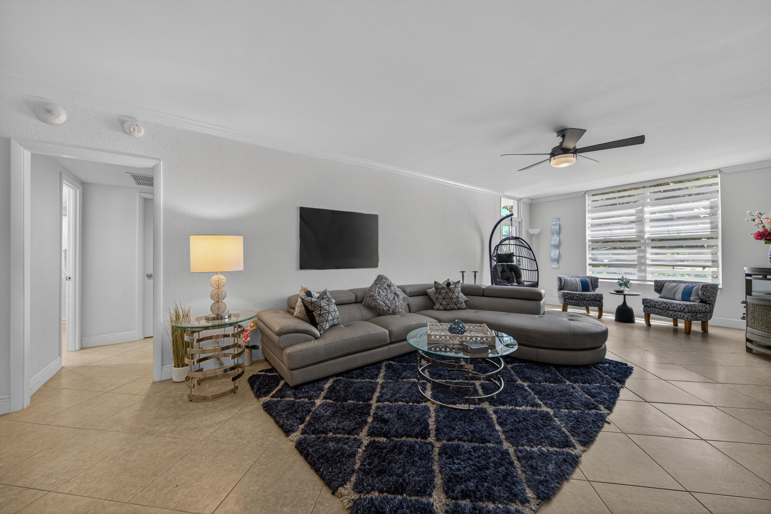 2851 South Ocean Boulevard, Unit 1N Boca Raton, FL 33432 - Photo 18 of 54 a living room with furniture and a flat screen tv
