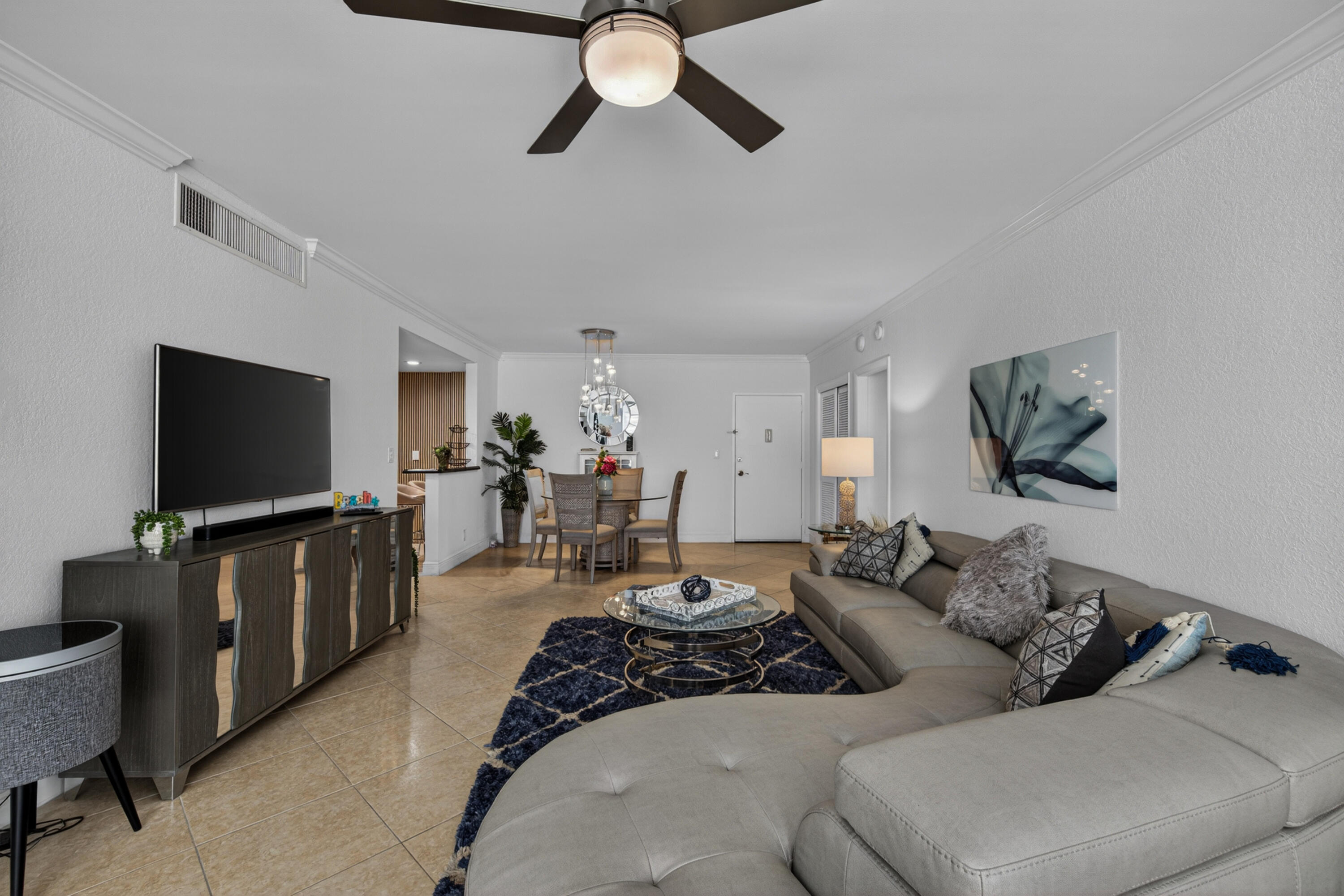 2851 South Ocean Boulevard, Unit 1N Boca Raton, FL 33432 - Photo 19 of 54 a living room with furniture and a flat screen tv