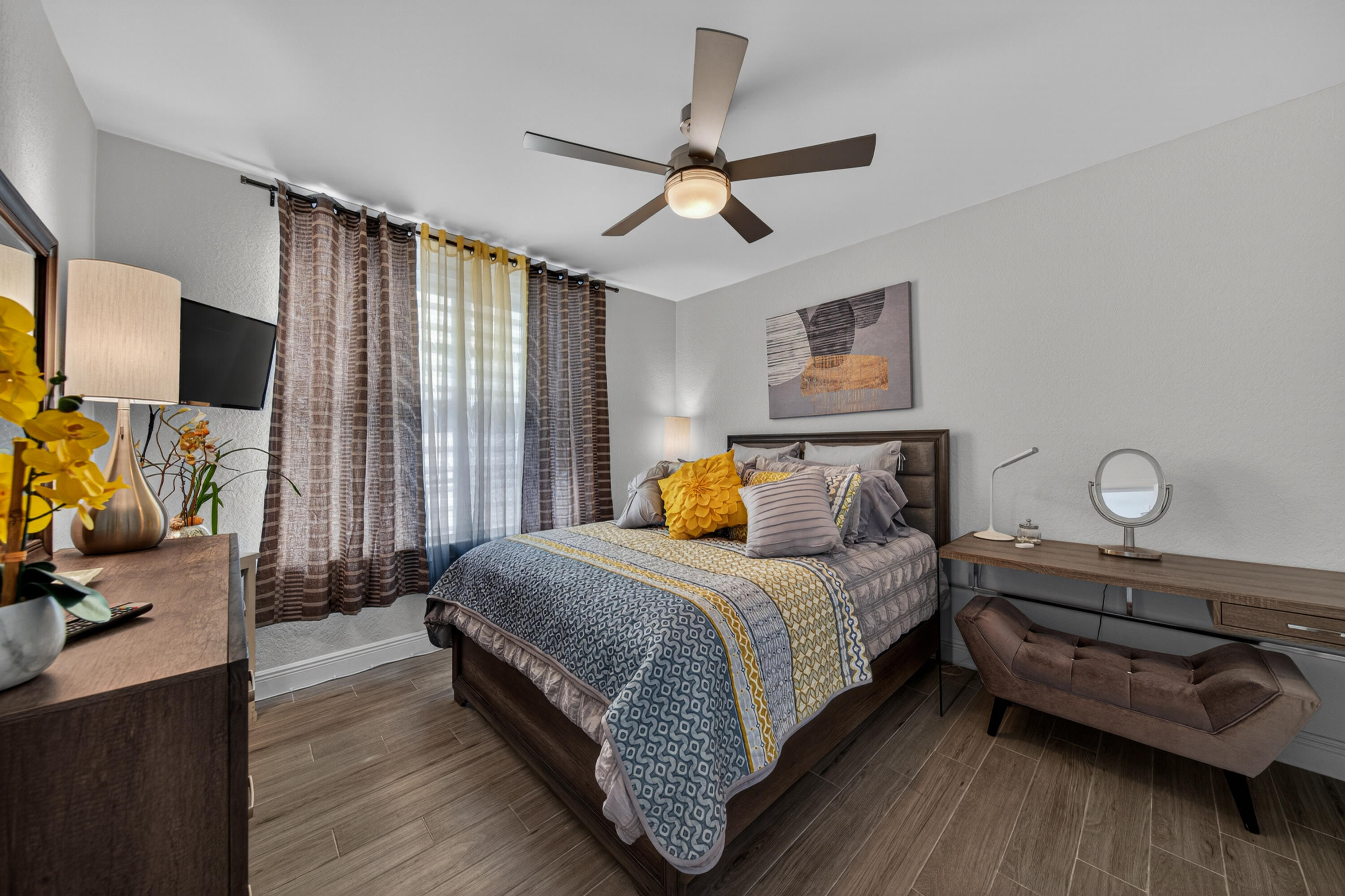 2851 South Ocean Boulevard, Unit 1N Boca Raton, FL 33432 - Photo 23 of 54 a bedroom with a bed and a flat tv screen on dresser