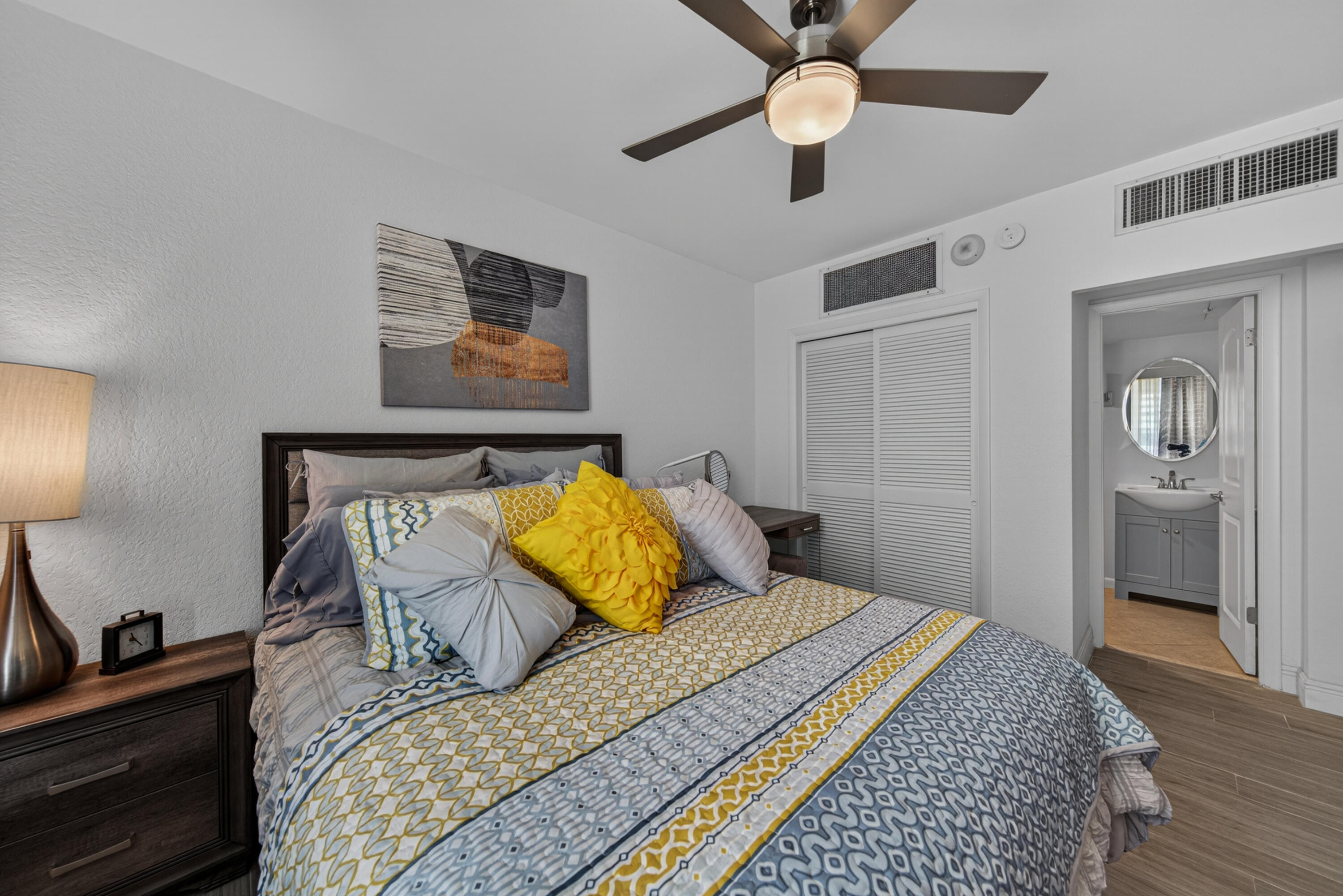 2851 South Ocean Boulevard, Unit 1N Boca Raton, FL 33432 - Photo 25 of 54 a bedroom with a bed and wooden floor