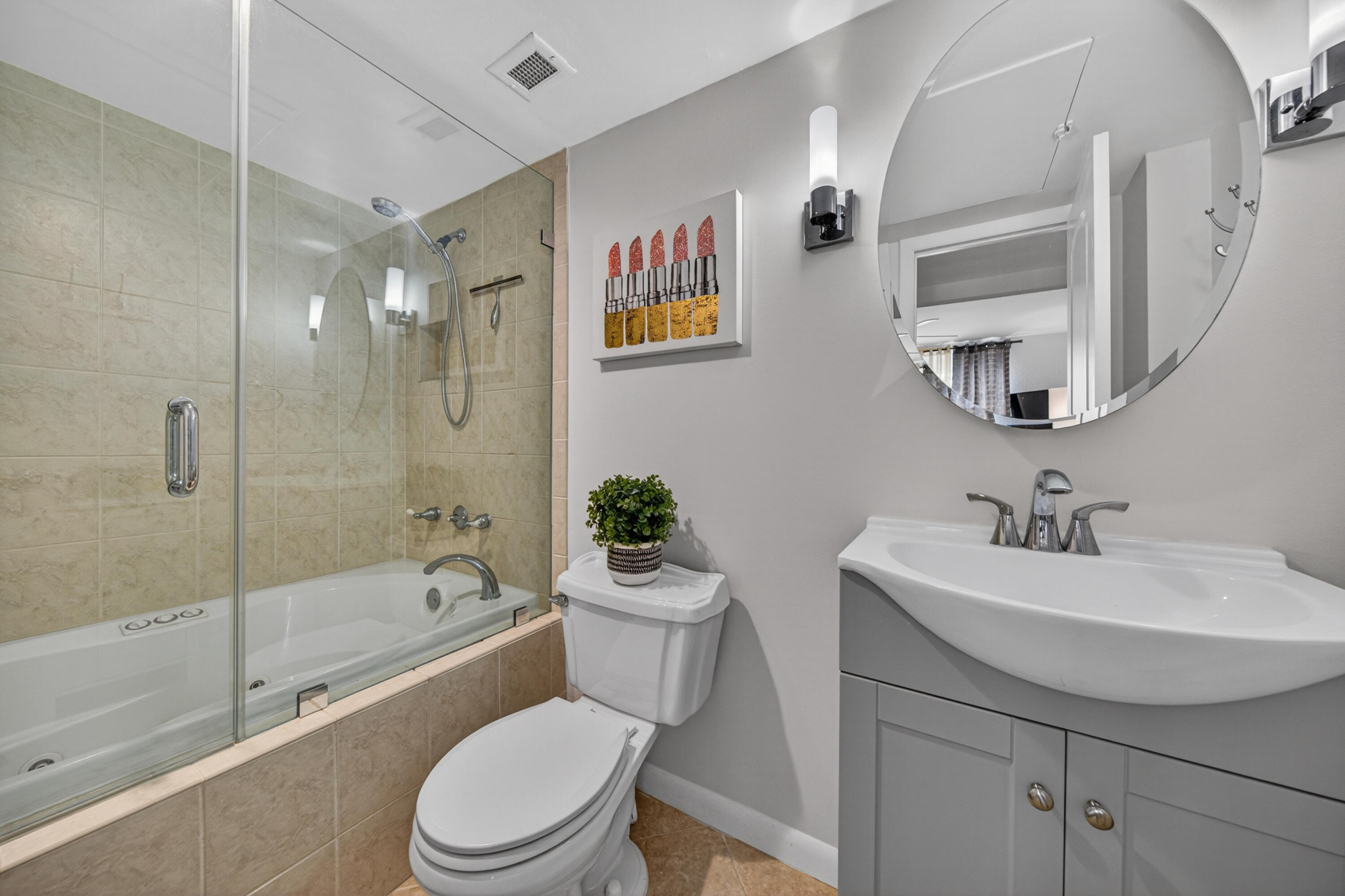 2851 South Ocean Boulevard, Unit 1N Boca Raton, FL 33432 - Photo 27 of 54 a bathroom with a sink a toilet and a mirror