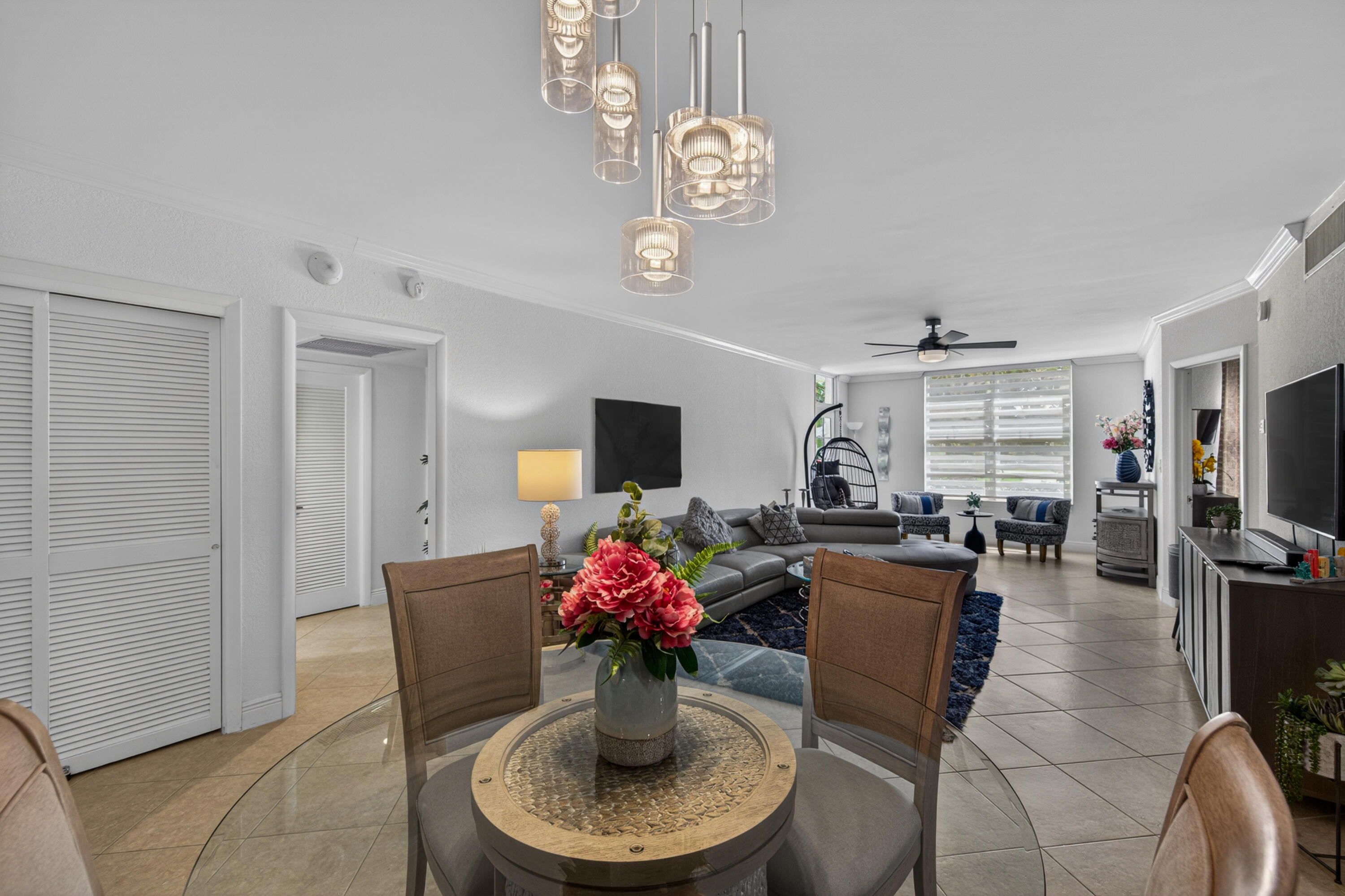 2851 South Ocean Boulevard, Unit 1N Boca Raton, FL 33432 - Photo 3 of 54 a dining room with furniture a chandelier and window