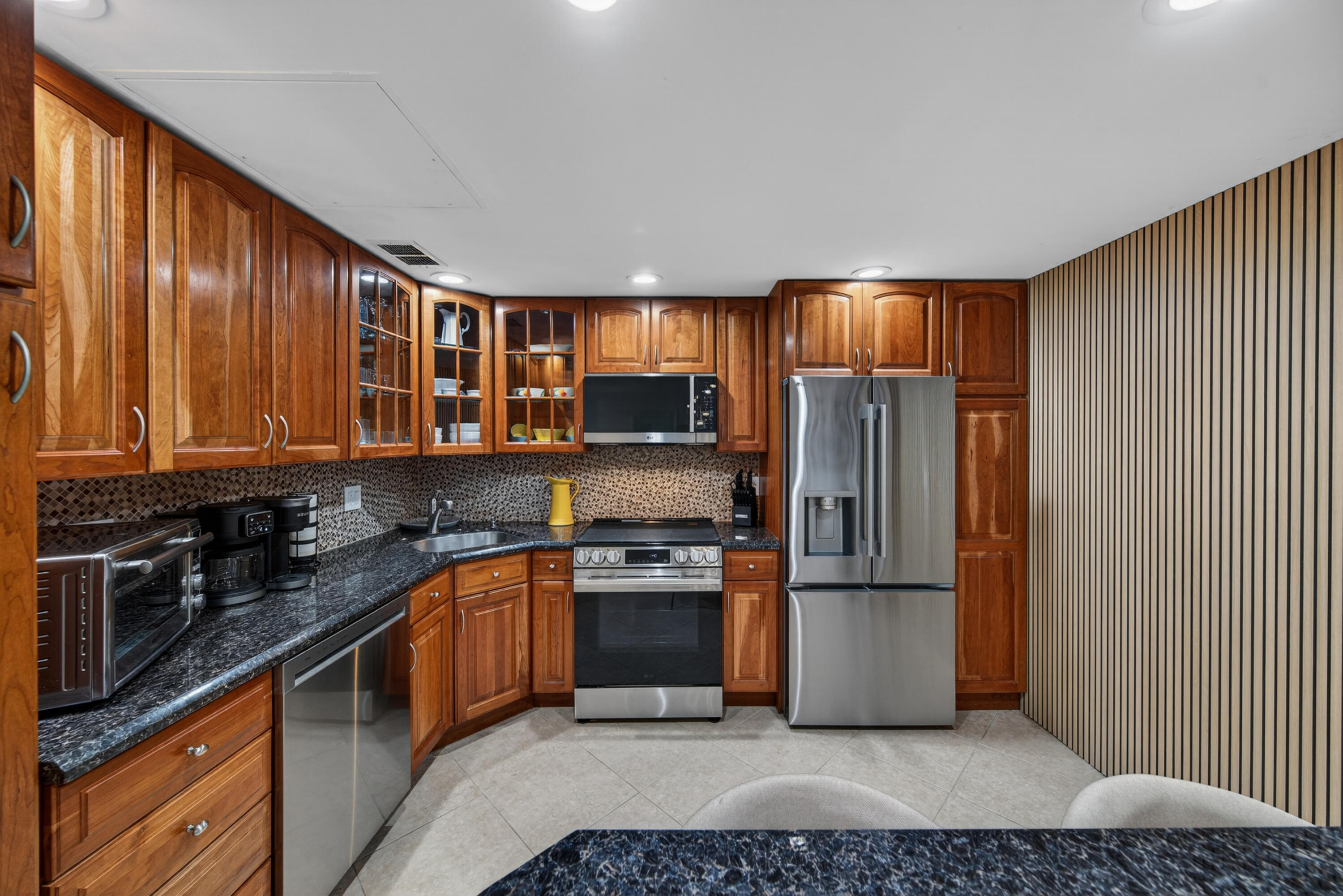 2851 South Ocean Boulevard, Unit 1N Boca Raton, FL 33432 - Photo 4 of 54 a kitchen with stainless steel appliances granite countertop a refrigerator stove and sink