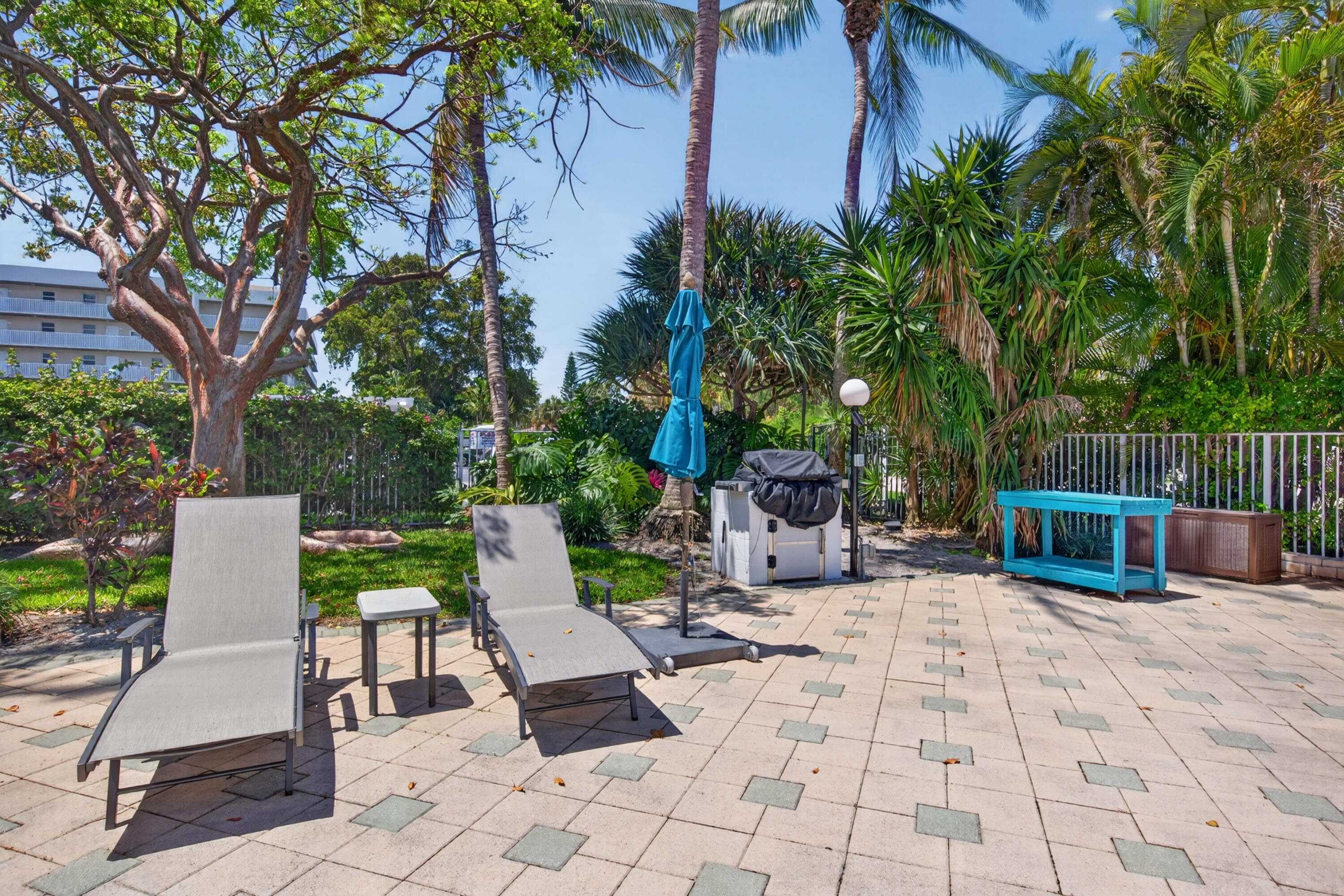 2851 South Ocean Boulevard, Unit 1N Boca Raton, FL 33432 - Photo 42 of 54 a view of backyard with seating space and trees