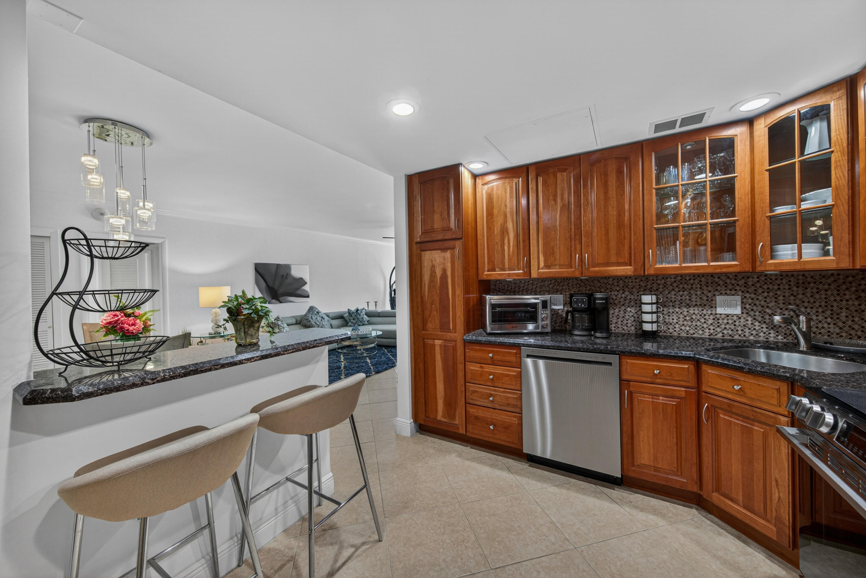 2851 South Ocean Boulevard, Unit 1N Boca Raton, FL 33432 - Photo 7 of 54 a kitchen with stainless steel appliances granite countertop a sink and cabinets