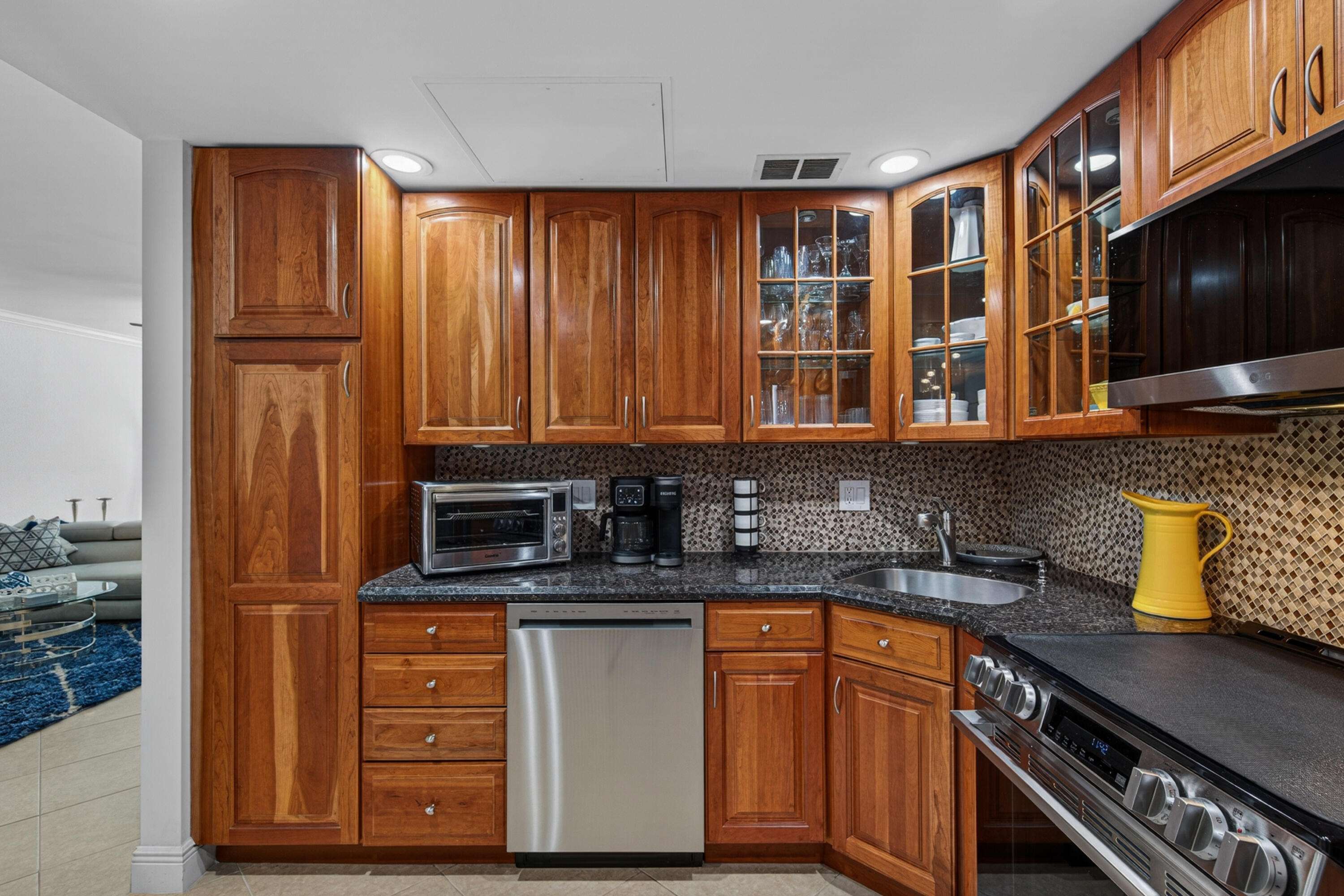 2851 South Ocean Boulevard, Unit 1N Boca Raton, FL 33432 - Photo 9 of 54 a kitchen with stainless steel appliances granite countertop a sink stove and cabinets
