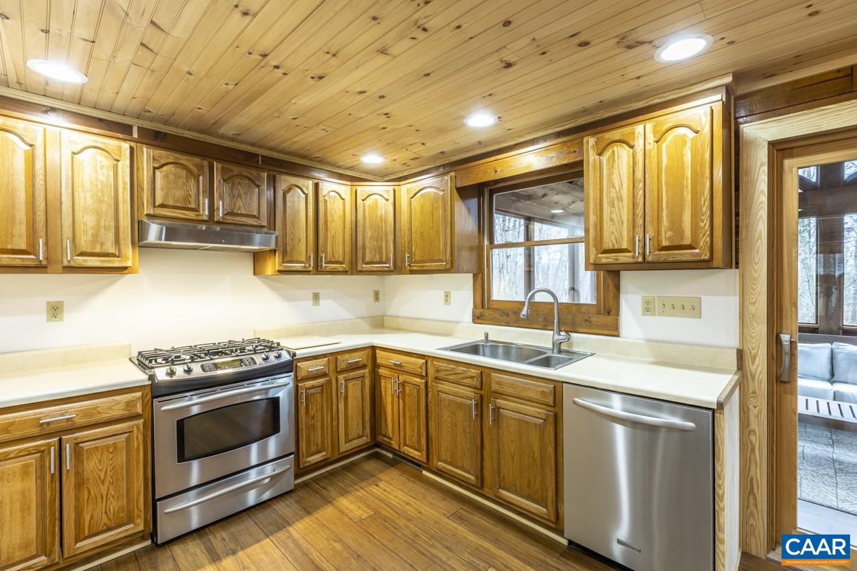 1151 Ridgeview Road Reva, VA 22735 - Photo 27 of 74 a kitchen with stainless steel appliances granite countertop wooden cabinets stove top oven and sink