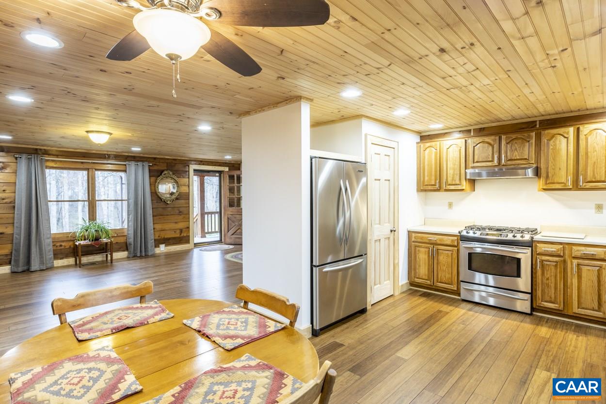 1151 Ridgeview Road Reva, VA 22735 - Photo 31 of 74 a kitchen with stainless steel appliances granite countertop a refrigerator a stove and a wooden floors