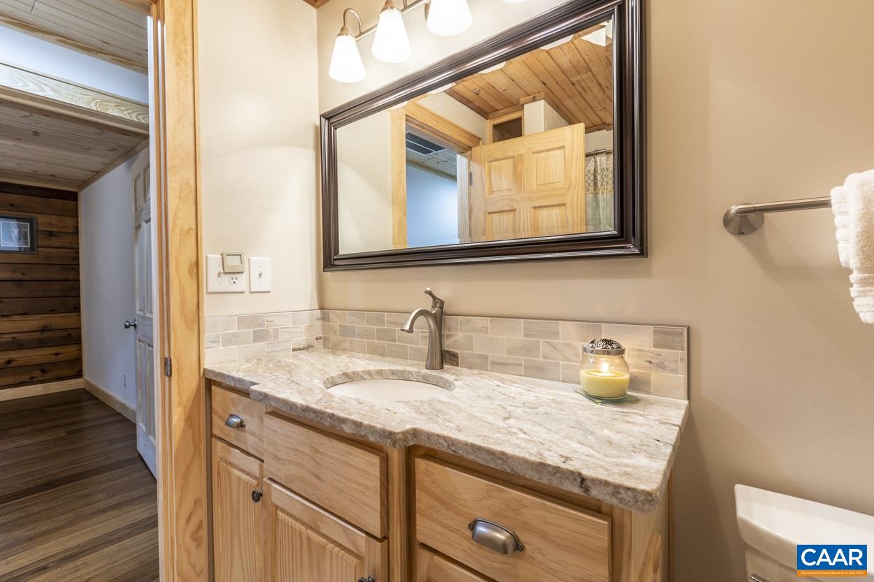 1151 Ridgeview Road Reva, VA 22735 - Photo 34 of 74 a bathroom with a granite countertop sink and a mirror
