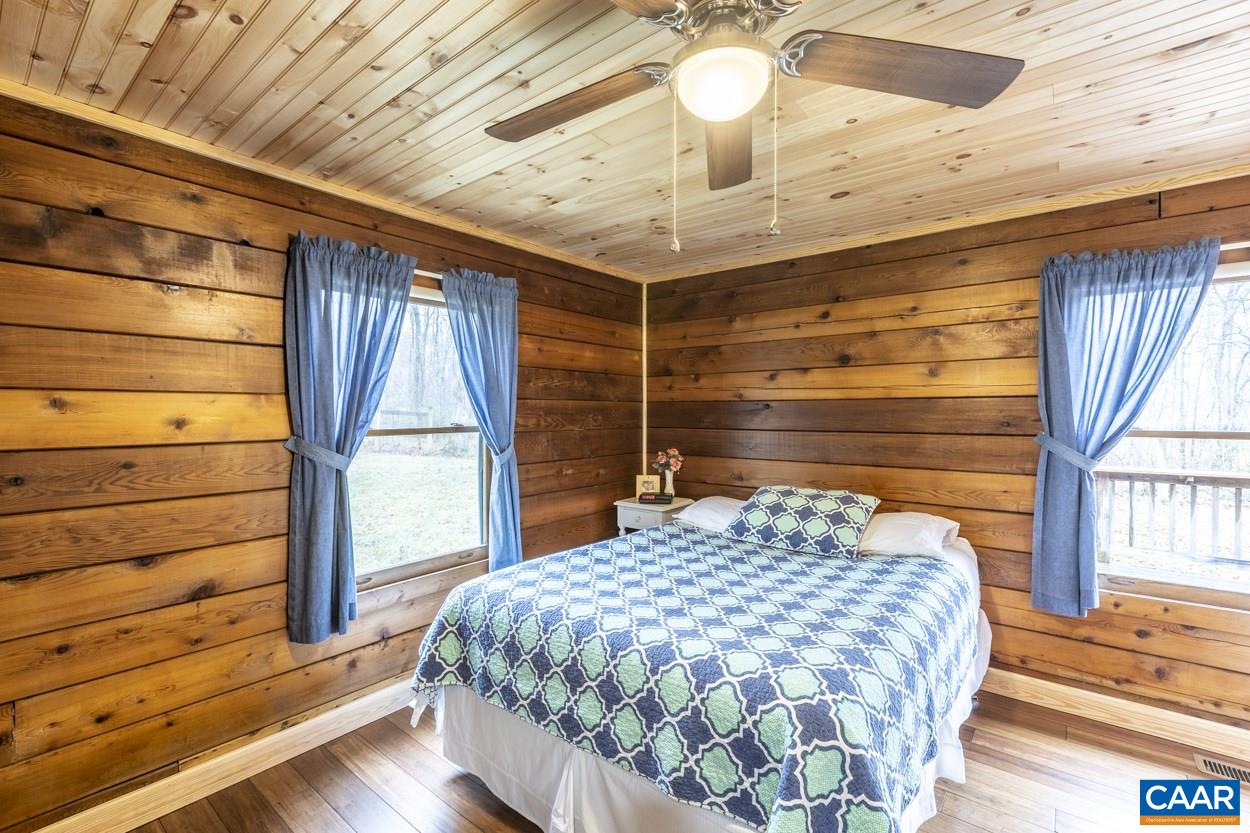 1151 Ridgeview Road Reva, VA 22735 - Photo 37 of 74 a bedroom with a bed and a chandelier