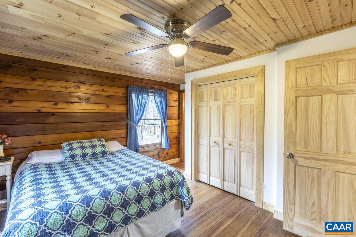 1151 Ridgeview Road Reva, VA 22735 - Photo 39 of 74 a bedroom with a bed and a chandelier