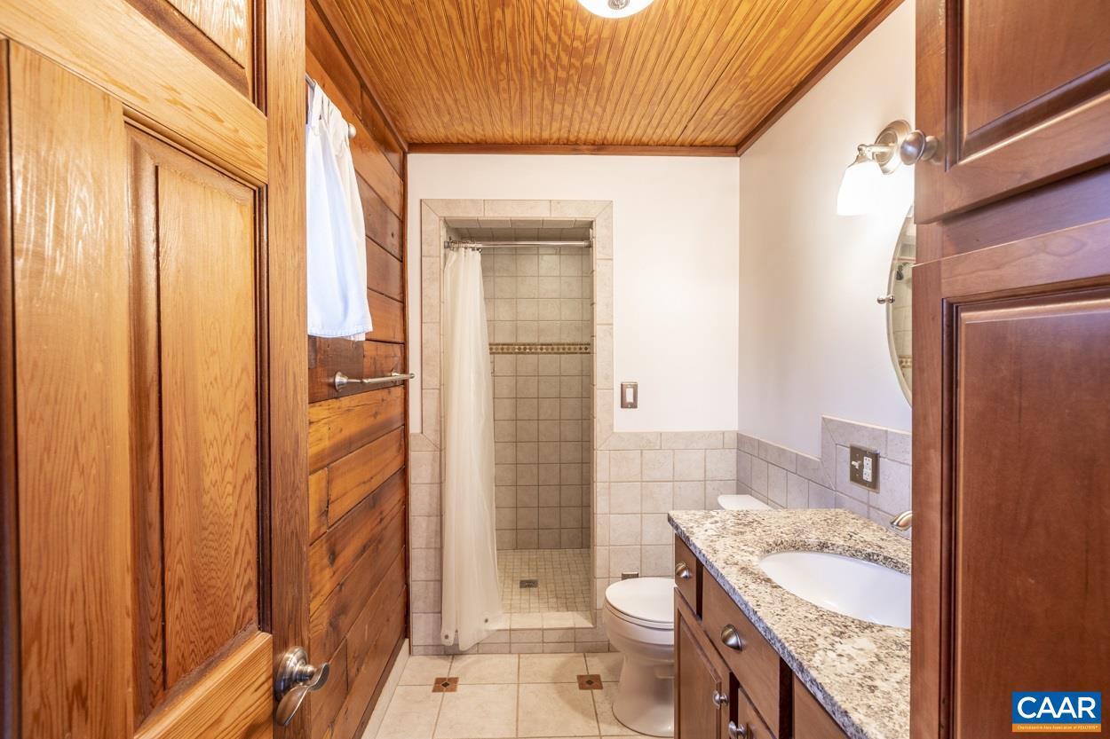 1151 Ridgeview Road Reva, VA 22735 - Photo 40 of 74 a bathroom with a granite countertop sink toilet and shower