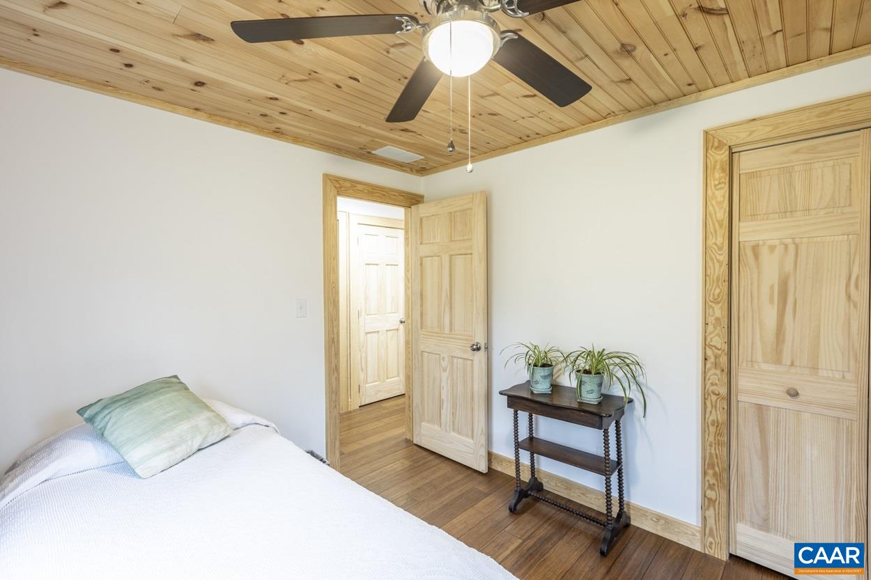 1151 Ridgeview Road Reva, VA 22735 - Photo 47 of 74 a bedroom with a bed and a chandelier