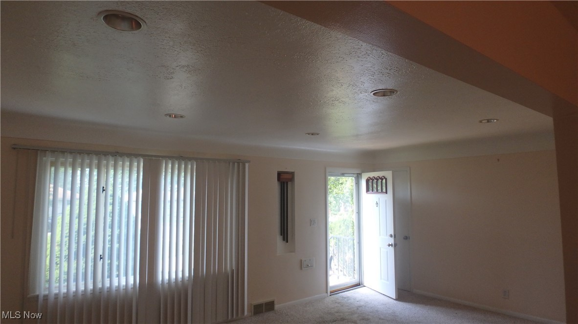 2901 Dentzler Road Parma, OH 44134 - Photo 8 of 25 Entrance foyer featuring light carpet, a textured ceiling, and recessed lighting