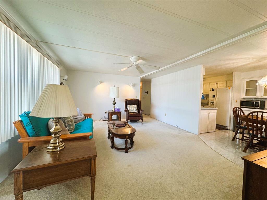 202 Aspen Circle Leesburg, FL 34748 - Photo 12 of 34 a living room with furniture and a table