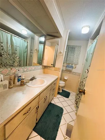 a bedroom with a bed dresser and a window