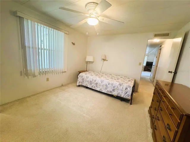 a bed room with a bed and a window