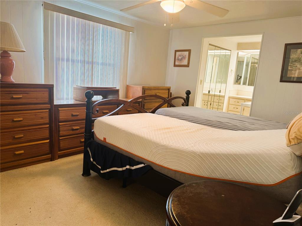 202 Aspen Circle Leesburg, FL 34748 - Photo 21 of 34 a bed room with a bed and a window