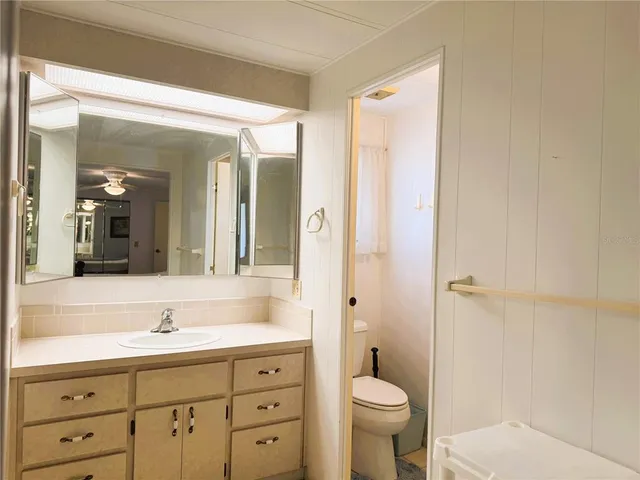 a bathroom with a sink mirror toilet and bathtub