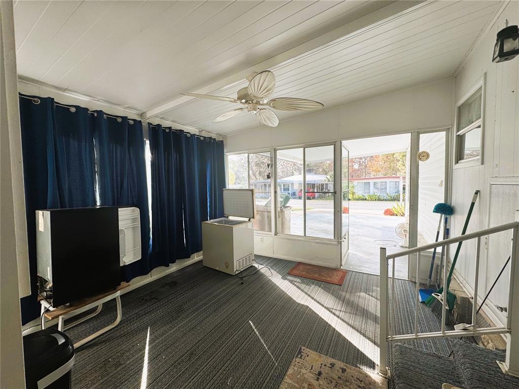 202 Aspen Circle Leesburg, FL 34748 - Photo 29 of 34 a living room with a flat screen tv and floor to ceiling window