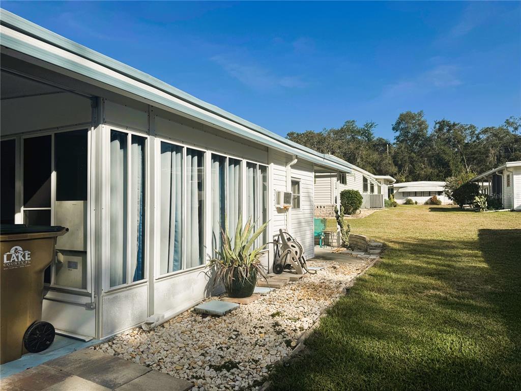 202 Aspen Circle Leesburg, FL 34748 - Photo 4 of 34 a front view of a house with garden