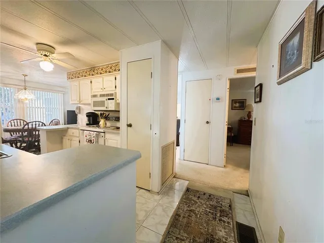 a kitchen with refrigerator and cabinets