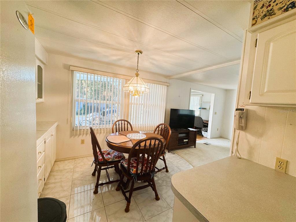 202 Aspen Circle Leesburg, FL 34748 - Photo 10 of 34 a view of a dining room with furniture window and outside view